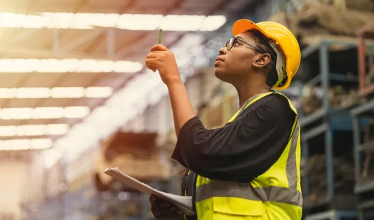 Employee in hard hat taking inventory
