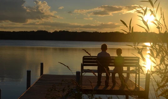 Two kids enjoying the views of the lake.
