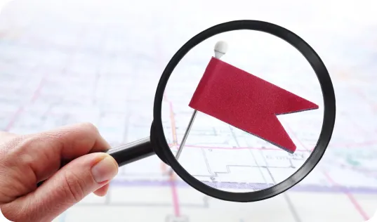 Microscope focused on red flag on a map